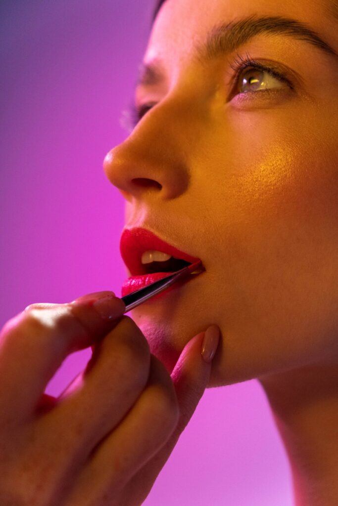 Applying red lipstick